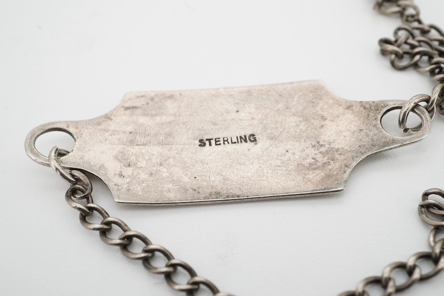 A silver military bracelet stamped sterling, and engraved ‘43450 G.W. Day, RAF C.ofE.’ X prisoner of war at Stalag prison. Condition - fair to good, one link requires rejoining.